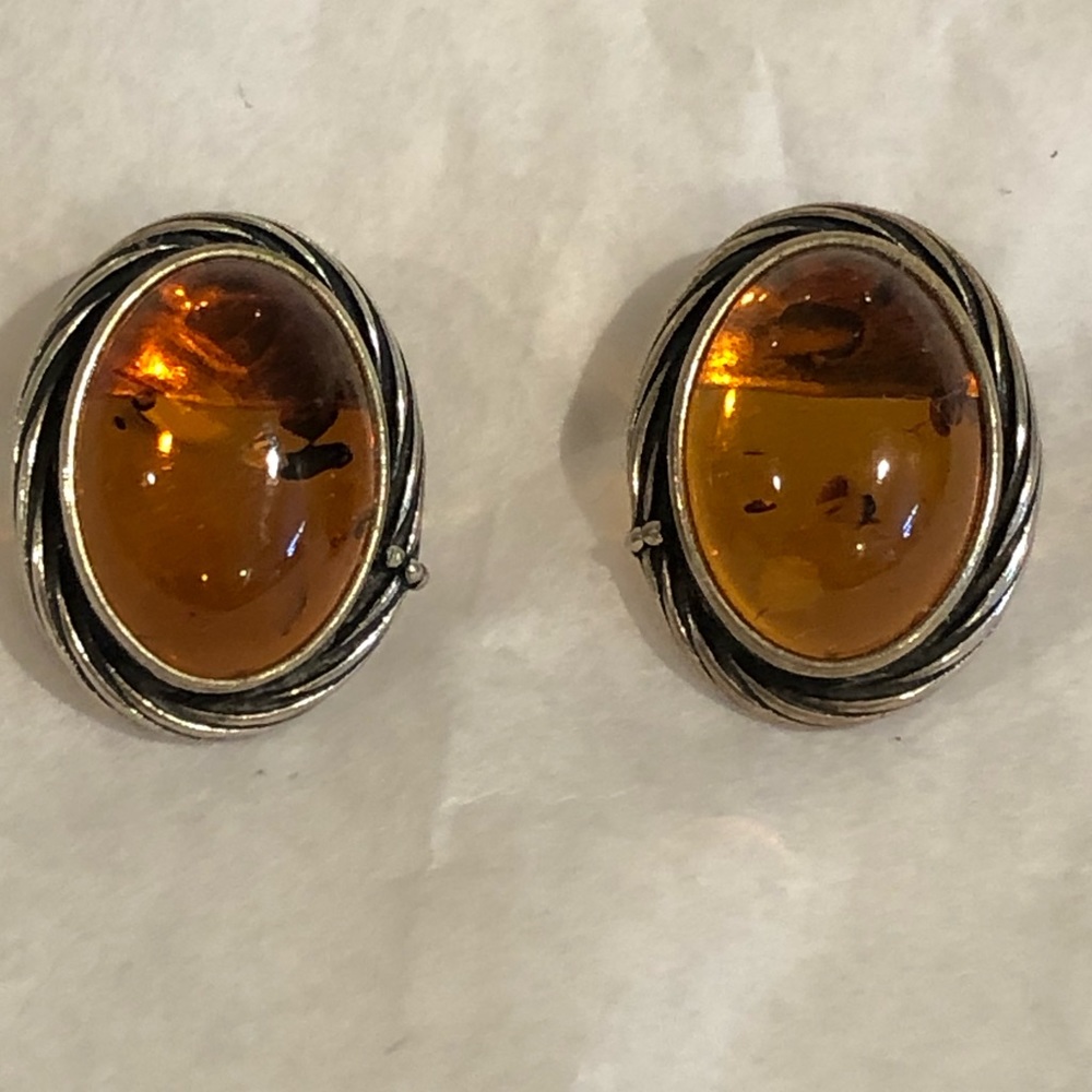 Oval Baltic Amber pierced earrings set in sterling silver.